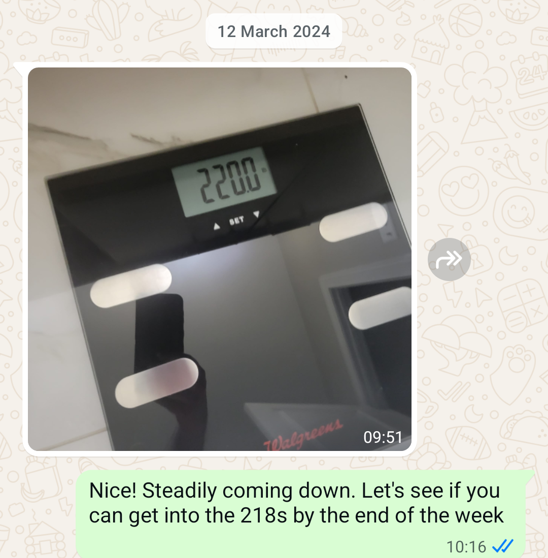 Scale photo showing 220lbs sent as a WhatsApp check-in